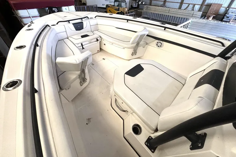 Slide: The Image of 2019 Wellcraft 302 Fisherman boat interior with white seating and storage compartments. - 36