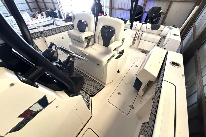 Slide: The Image of 2019 Wellcraft 302 Fisherman boat interior with dual seats and steering console. - 37