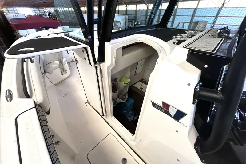 Slide: The Image of 2019 Wellcraft 302 Fisherman boat interior with open cabin door, showcasing seating and storage. - 39
