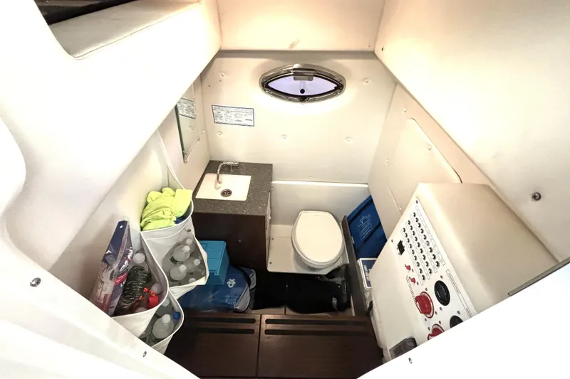 Slide: The Image of 2019 Wellcraft 302 Fisherman cabin with sink, toilet, and storage compartments. - 40