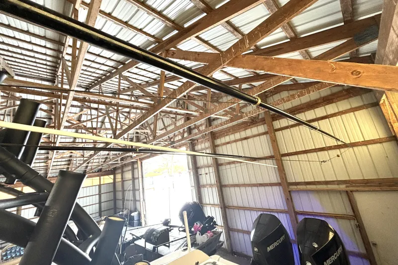 Slide: The Image of 2019 Wellcraft 302 Fisherman boat stored in a wooden garage with Mercury engines. - 43