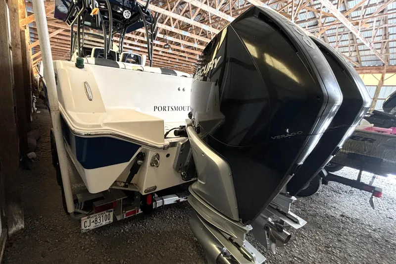 Slide: The Image of 2019 Wellcraft 302 Fisherman boat with dual Mercury Verado engines in a storage facility. - 8