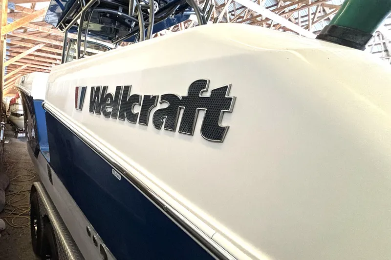 Slide: The Image of 2019 Wellcraft 302 Fisherman boat in storage, showcasing sleek design and branding. - 9