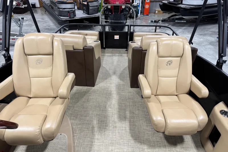 Slide: The Image of 2018 Lowe Retreat 250 RFL boat interior with beige leather seats and spacious layout. - 10