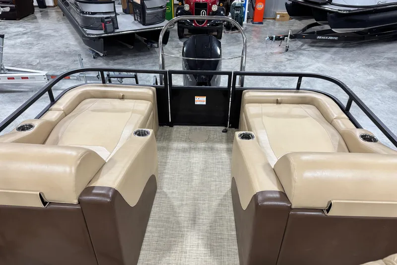 Slide: The Image of 2018 Lowe Retreat 250 RFL pontoon boat interior with beige seating and cup holders. - 12