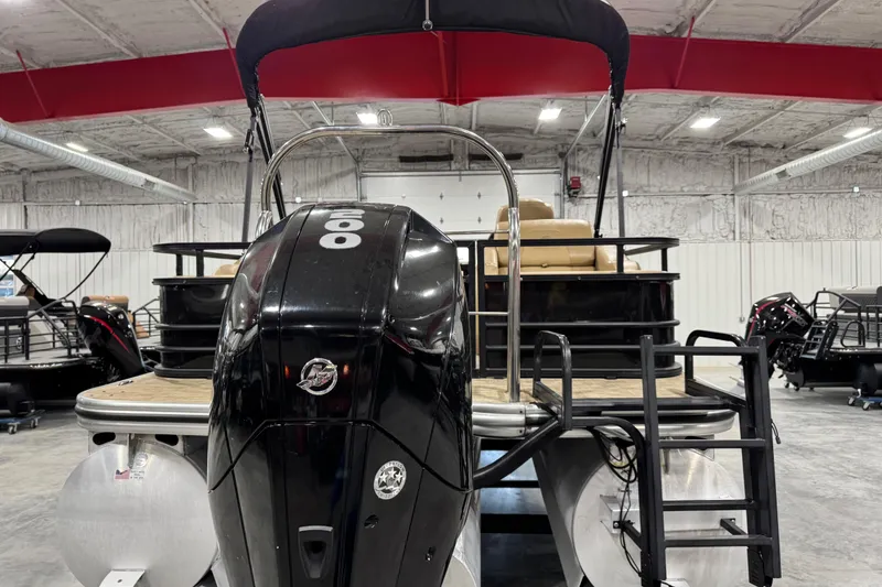 Slide: The Image of 2018 Lowe Retreat 250 RFL pontoon boat in a showroom, featuring a powerful outboard motor. - 5