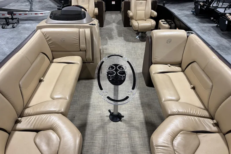 Slide: The Image of 2018 Lowe Retreat 250 RFL boat interior with beige seating and central cup holder. - 6