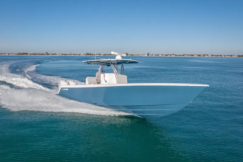 The Image of 2026 Contender 35 ST boat cruising on clear blue water under a sunny sky. - 0