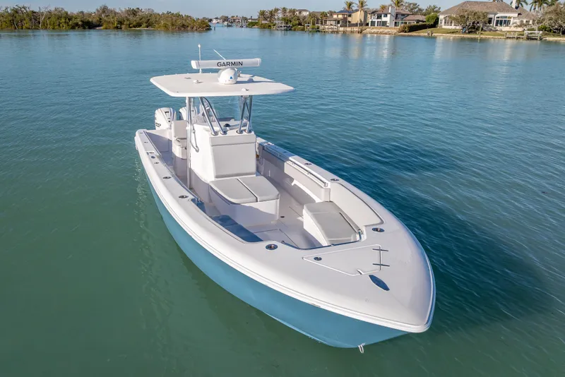 Slide: The Image of 2026 Contender 35 ST boat on calm water, featuring sleek design and Garmin equipment. - 10