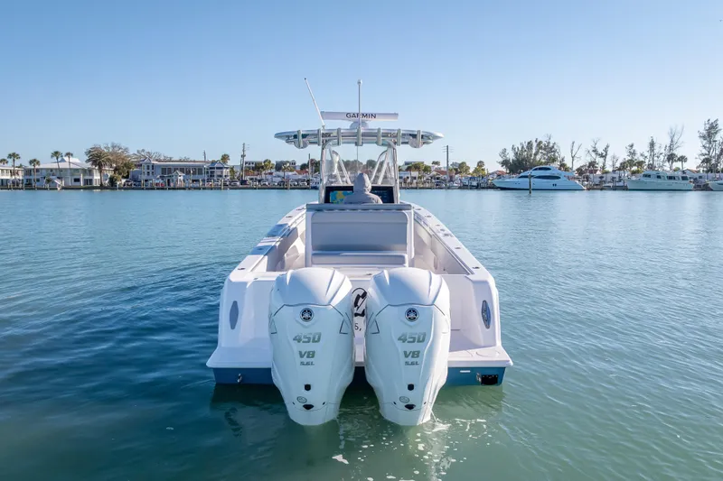 Slide: The Image of 2026 Contender 35 ST boat with twin 450 V8 engines on calm water. - 12