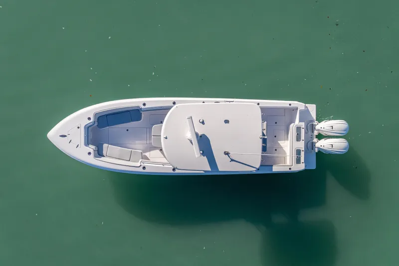 Slide: The Image of Aerial view of 2026 Contender 35 ST boat on calm green water. - 14