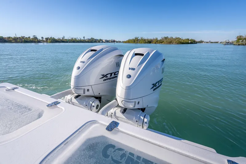 Slide: The Image of 2026 Contender 35 ST boat with dual Yamaha XTO Offshore V8 engines on calm water. - 15