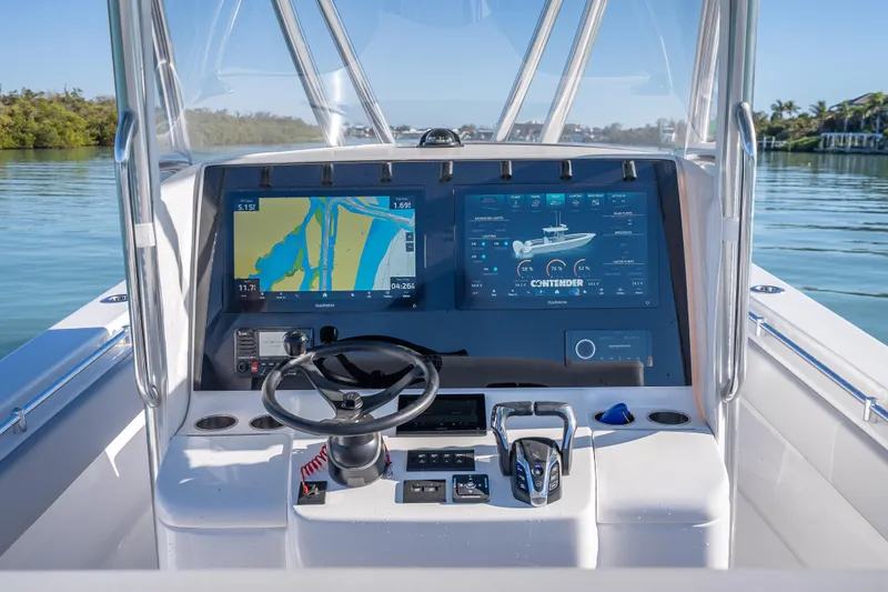 Slide: The Image of 2026 Contender 35 ST boat dashboard with advanced navigation screens and controls. - 17