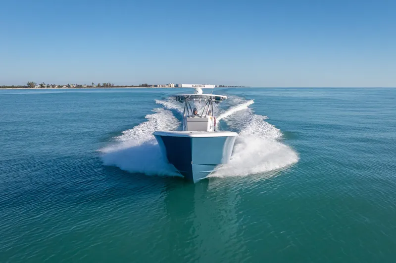 Slide: The Image of 2026 Contender 35 ST boat cruising on clear blue ocean waters. - 2