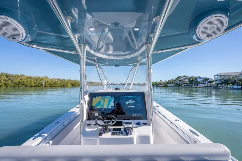 Slide: The Image of 2026 Contender 35 ST boat dashboard with navigation system on calm waters. - 20