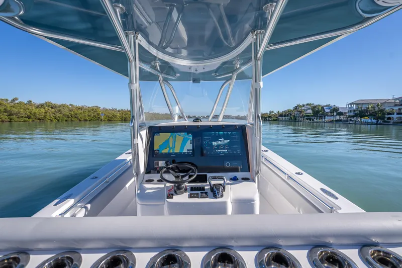 Slide: The Image of 2026 Contender 35 ST boat cockpit with advanced navigation system on calm waters. - 25