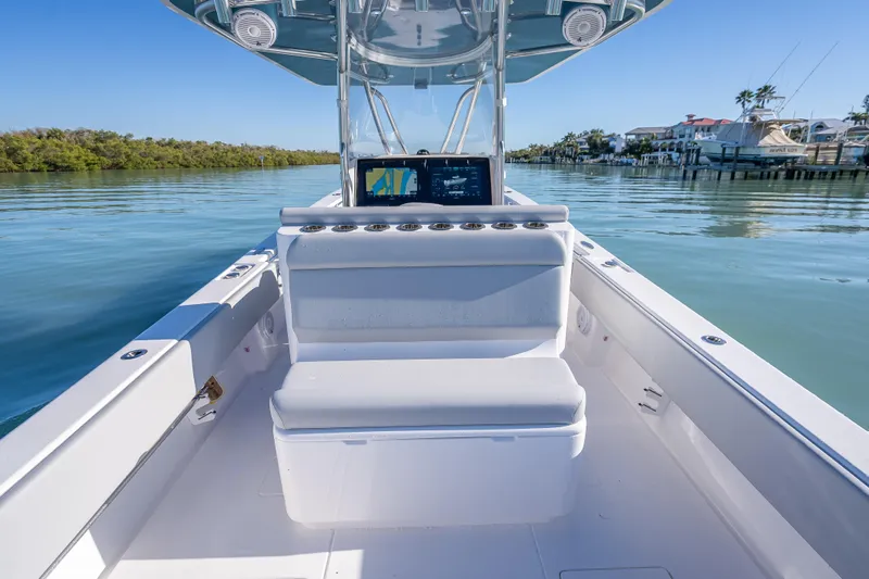 Slide: The Image of 2026 Contender 35 ST boat interior with seating and navigation system on calm water. - 26