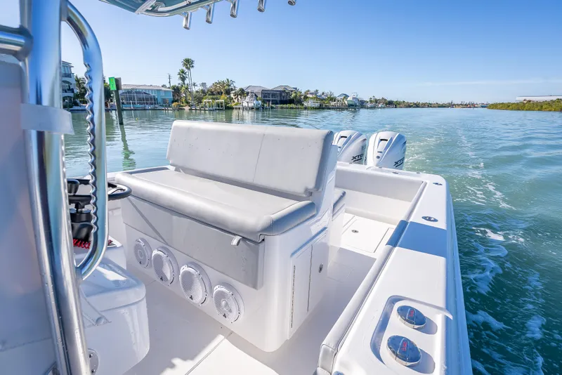 Slide: The Image of 2026 Contender 35 ST boat cruising on a sunny day, showcasing sleek design and powerful engines. - 28