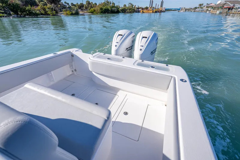 Slide: The Image of 2026 Contender 35 ST boat with dual outboard engines on a scenic waterway. - 29