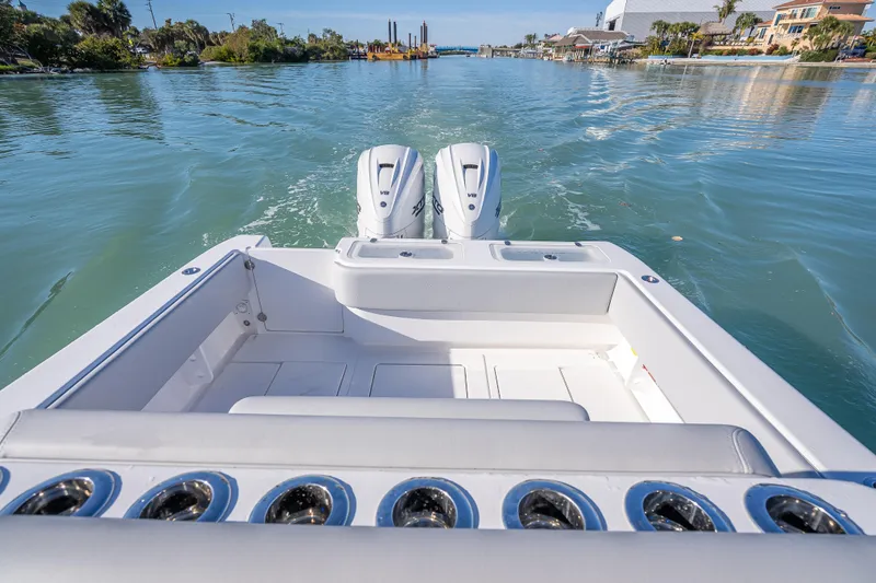 Slide: The Image of 2026 Contender 35 ST boat with dual engines cruising on a serene waterway. - 31