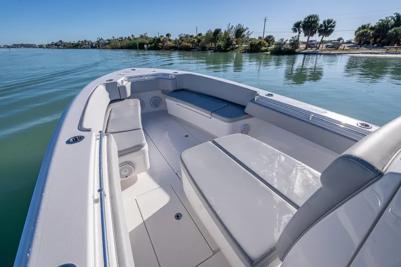 Slide: The Image of 2026 Contender 35 ST boat interior with cushioned seating on calm water. - 32