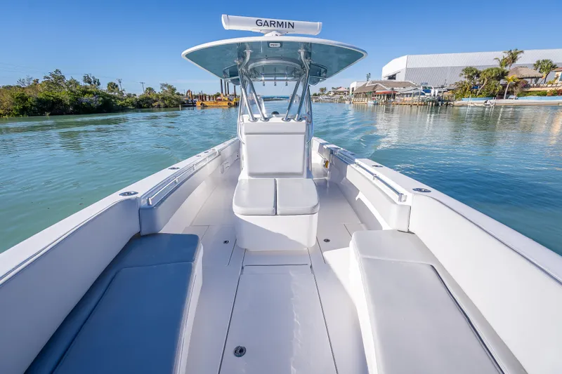 Slide: The Image of 2026 Contender 35 ST boat on calm water, featuring spacious seating and Garmin equipment. - 33