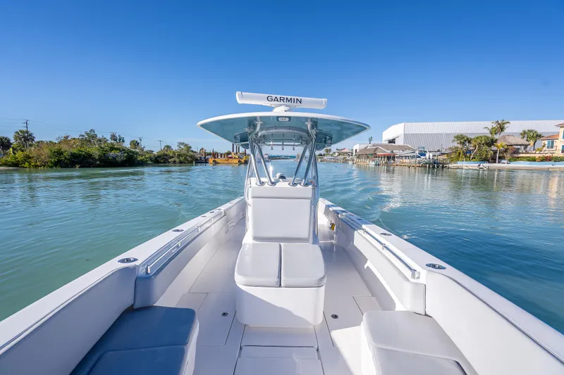 Slide: The Image of 2026 Contender 35 ST boat on calm water, featuring Garmin navigation system. - 35