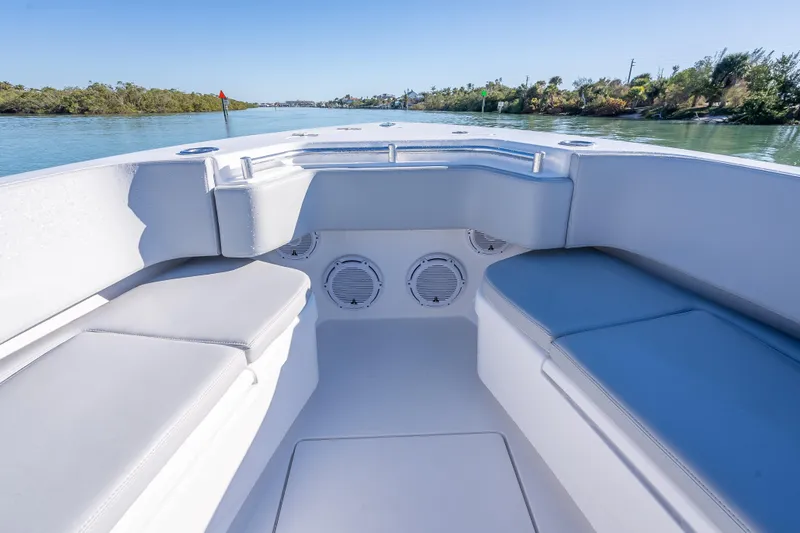 Slide: The Image of 2026 Contender 35 ST boat interior with cushioned seating and scenic waterway view. - 37
