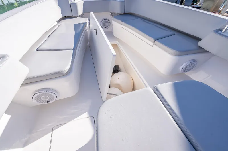 Slide: The Image of 2026 Contender 35 ST boat interior with cushioned seating and storage compartment. - 38