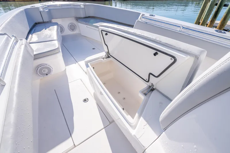 Slide: The Image of 2026 Contender 35 ST boat interior with open storage compartment and cushioned seating. - 39