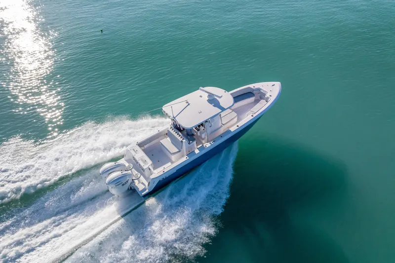 Slide: The Image of 2026 Contender 35 ST boat cruising on clear blue water, aerial view. - 4