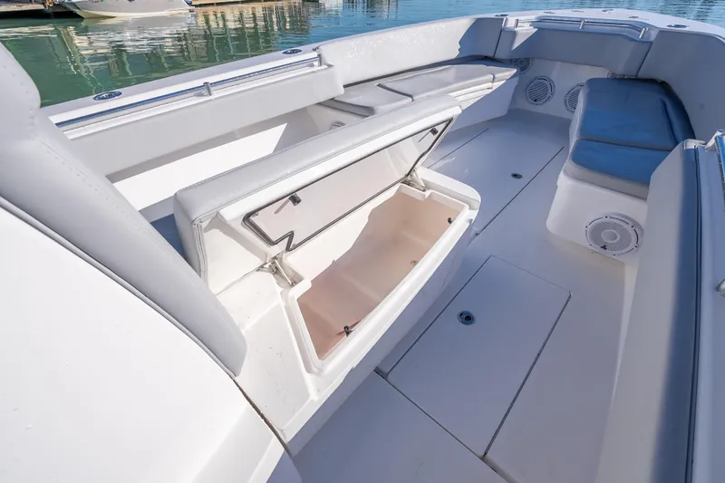 Slide: The Image of 2026 Contender 35 ST boat interior with open storage compartment and cushioned seating. - 40