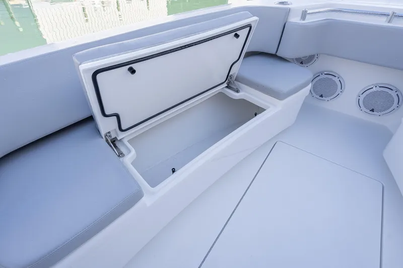 Slide: The Image of 2026 Contender 35 ST boat interior with open storage compartment and cushioned seating. - 41
