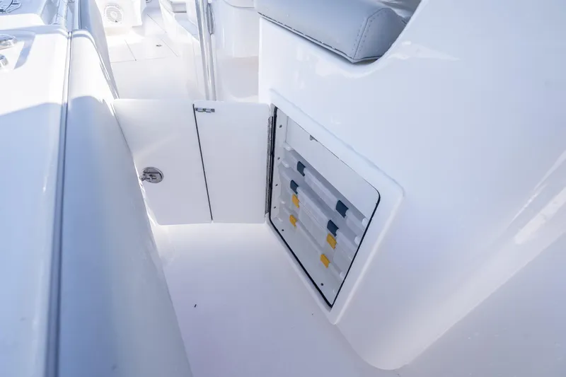 Slide: The Image of 2026 Contender 35 ST boat interior storage compartment with open door. - 45