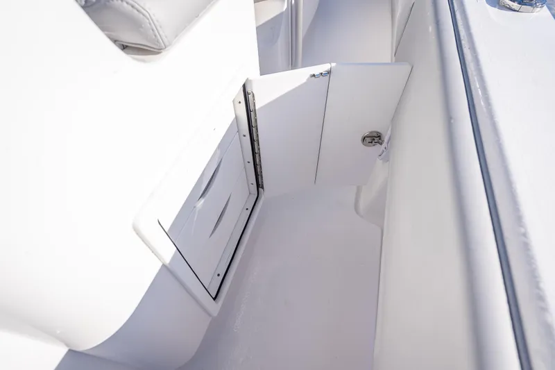Slide: The Image of 2026 Contender 35 ST boat interior storage compartment with open door. - 46