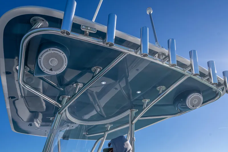 Slide: The Image of 2026 Contender 35 ST boat with sleek T-top and integrated speakers against blue sky. - 47