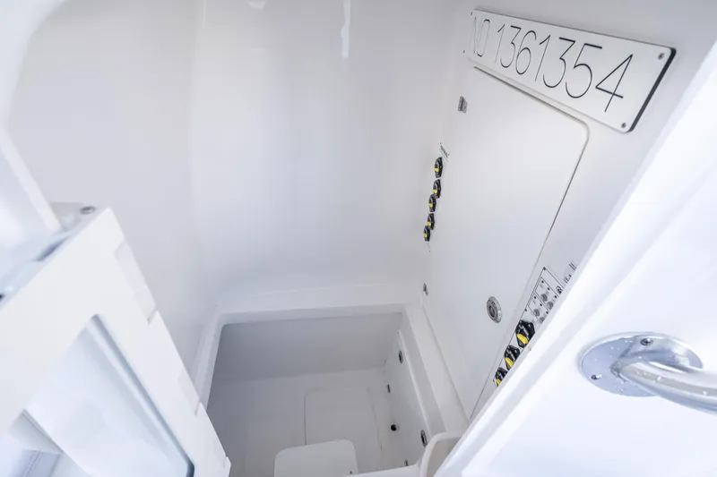 Slide: The Image of Interior of 2026 Contender 35 ST boat, featuring storage compartment and control panel. - 48