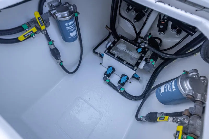 Slide: The Image of 2026 Contender 35 ST boat engine compartment with Yamaha fuel filters and hoses. - 49