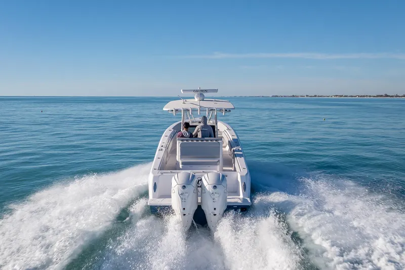 Slide: The Image of 2026 Contender 35 ST boat cruising on open water, rear view. - 6