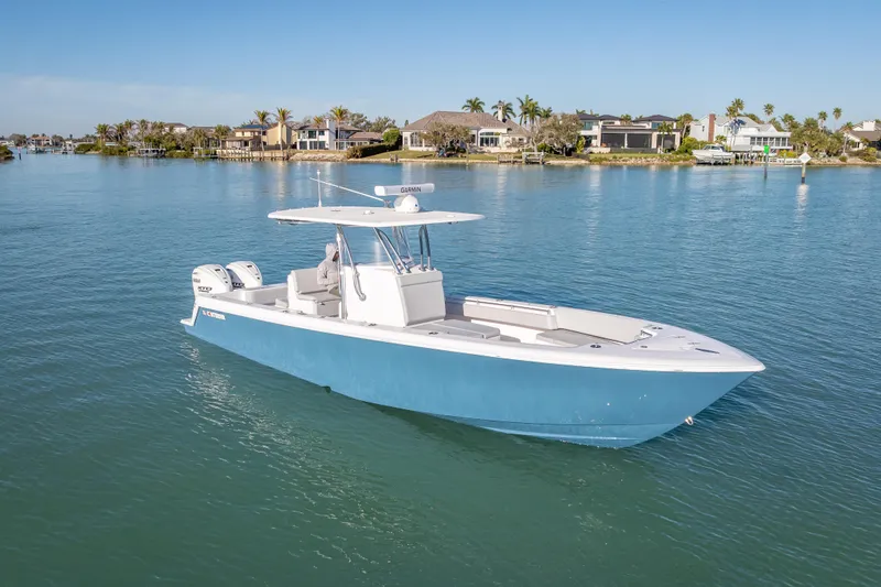 Slide: The Image of 2026 Contender 35 ST boat on calm water, coastal homes in background. - 7