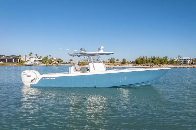Slide: The Image of 2026 Contender 35 ST boat on calm water, featuring sleek blue design and Yamaha engines. - 8