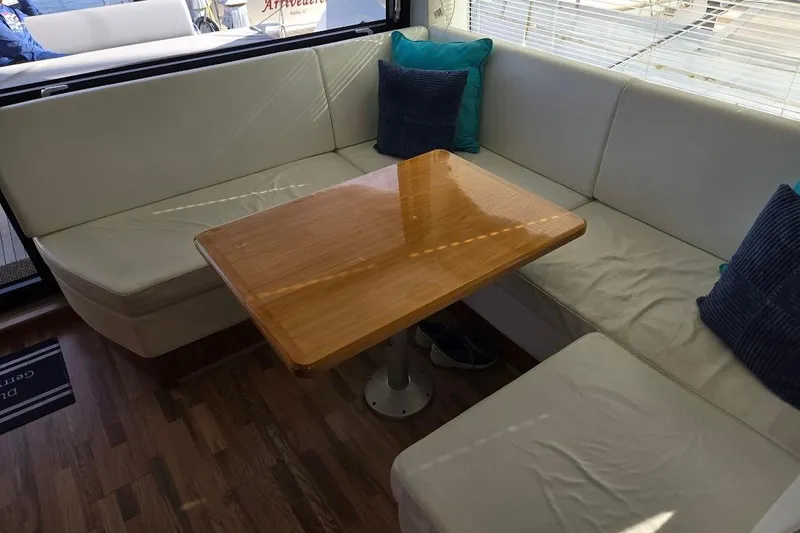 Slide: The Image of Interior of 2019 Sunseeker Predator 50 yacht with cozy seating and wooden table. - 23