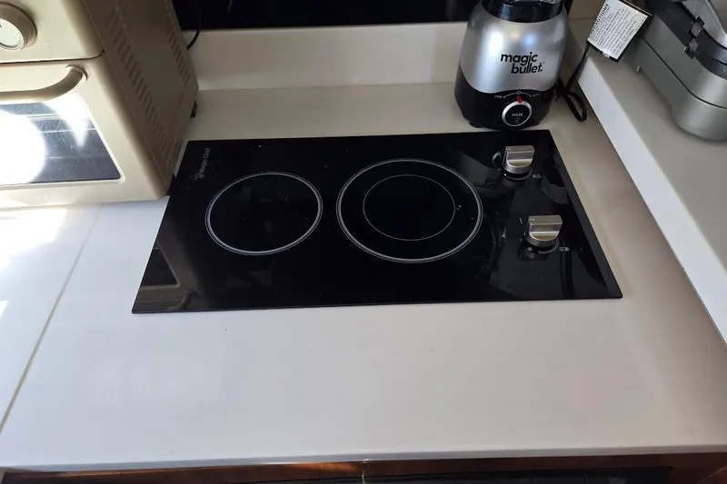 Slide: The Image of Modern kitchen area in 2019 Sunseeker Predator 50 yacht with stovetop and appliances. - 31