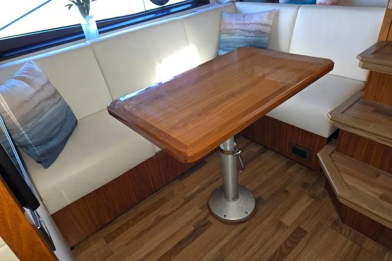 Slide: The Image of Interior of 2019 Sunseeker Predator 50 yacht with wooden table and white seating. - 38