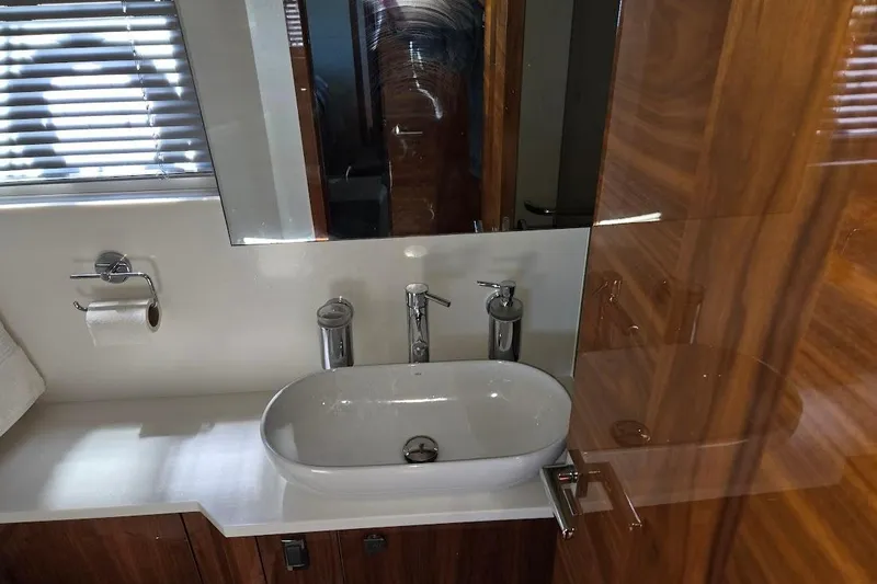 Slide: The Image of Luxurious bathroom in 2019 Sunseeker Predator 50 yacht with modern sink and wooden cabinetry. - 46