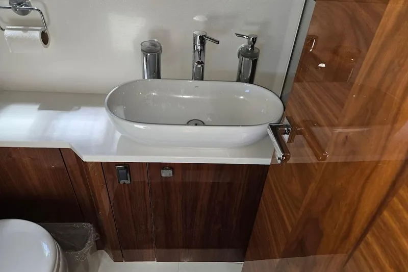 Slide: The Image of Luxurious bathroom sink in 2019 Sunseeker Predator 50 yacht with wooden cabinetry. - 47