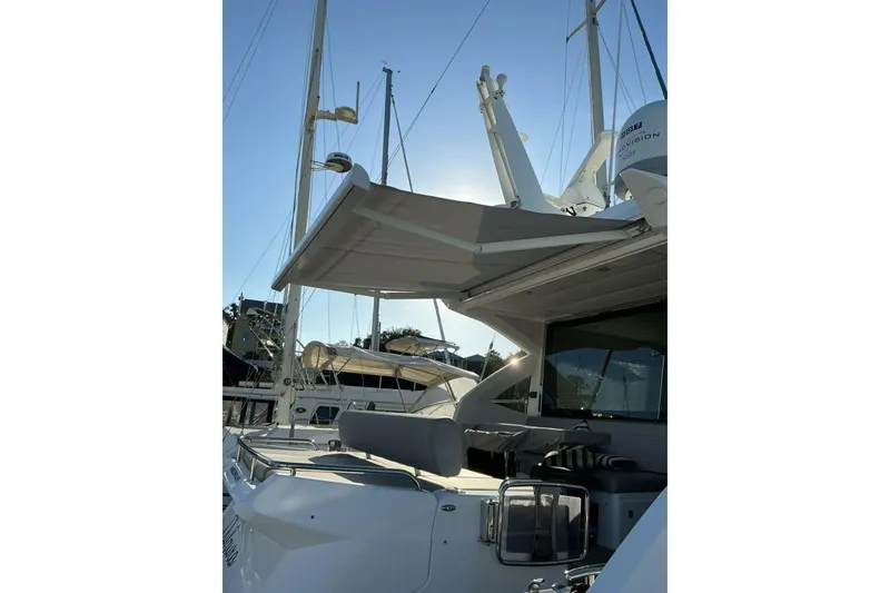 Slide: The Image of 2019 Sunseeker Predator 50 yacht with sunshade, docked under clear blue sky. - 56