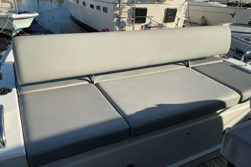 Slide: The Image of Sunseeker Predator 50 yacht 2019, featuring a spacious gray cushioned seating area. - 61