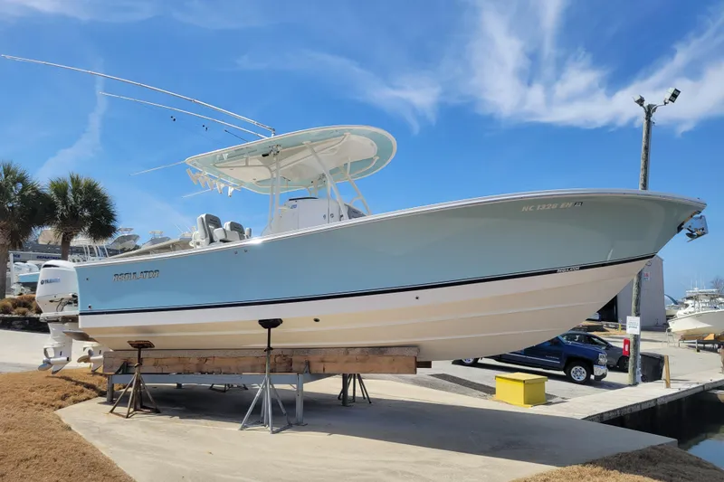 The Image of 2018 Regulator 28 Forward Seating boat on display under clear blue sky. - 0