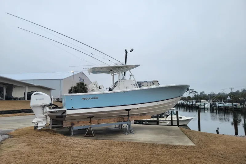 Slide: The Image of 2018 Regulator 28 Forward Seating boat on display near marina. - 2